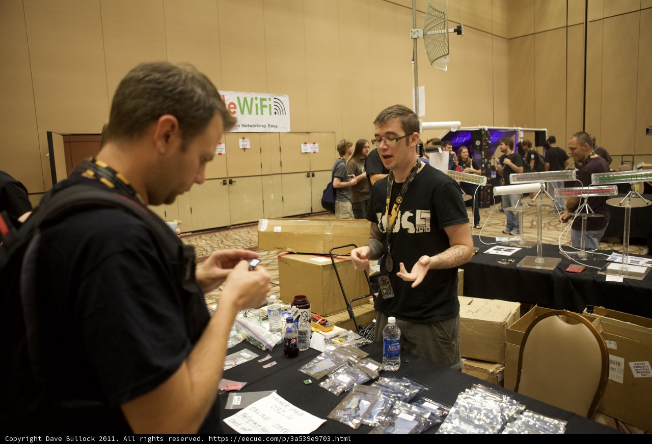 Emilio Estevez examines electronics with fellow tech enthusiast