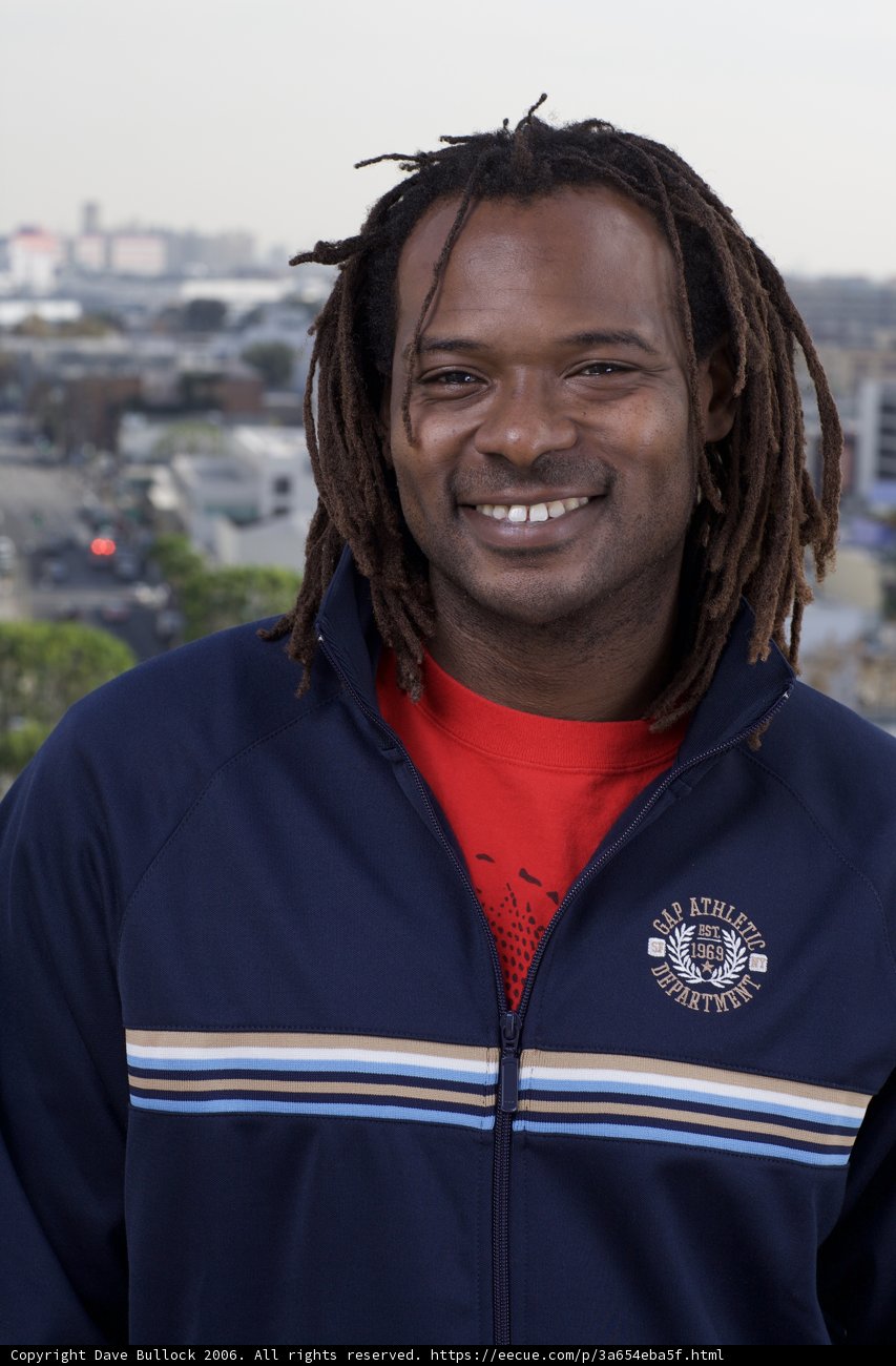 Happy man with dreadlocks outside
