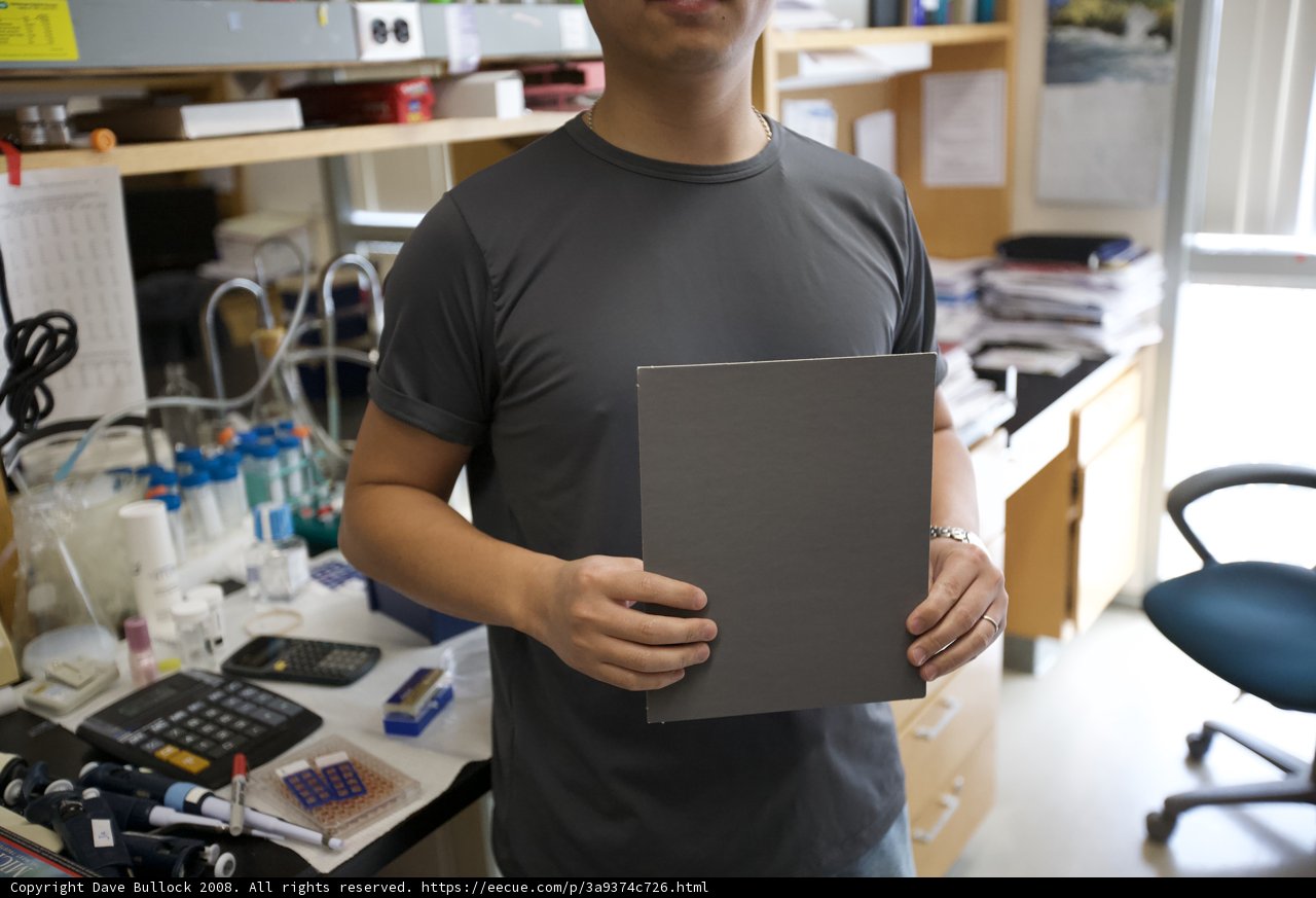 Man Holding Paper Check