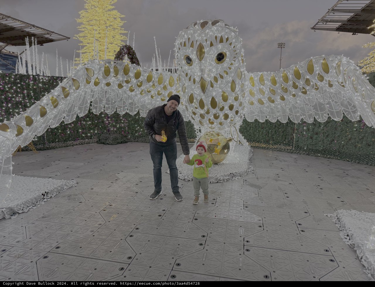 Father and Child with Giant Snowy Owl Sculpture