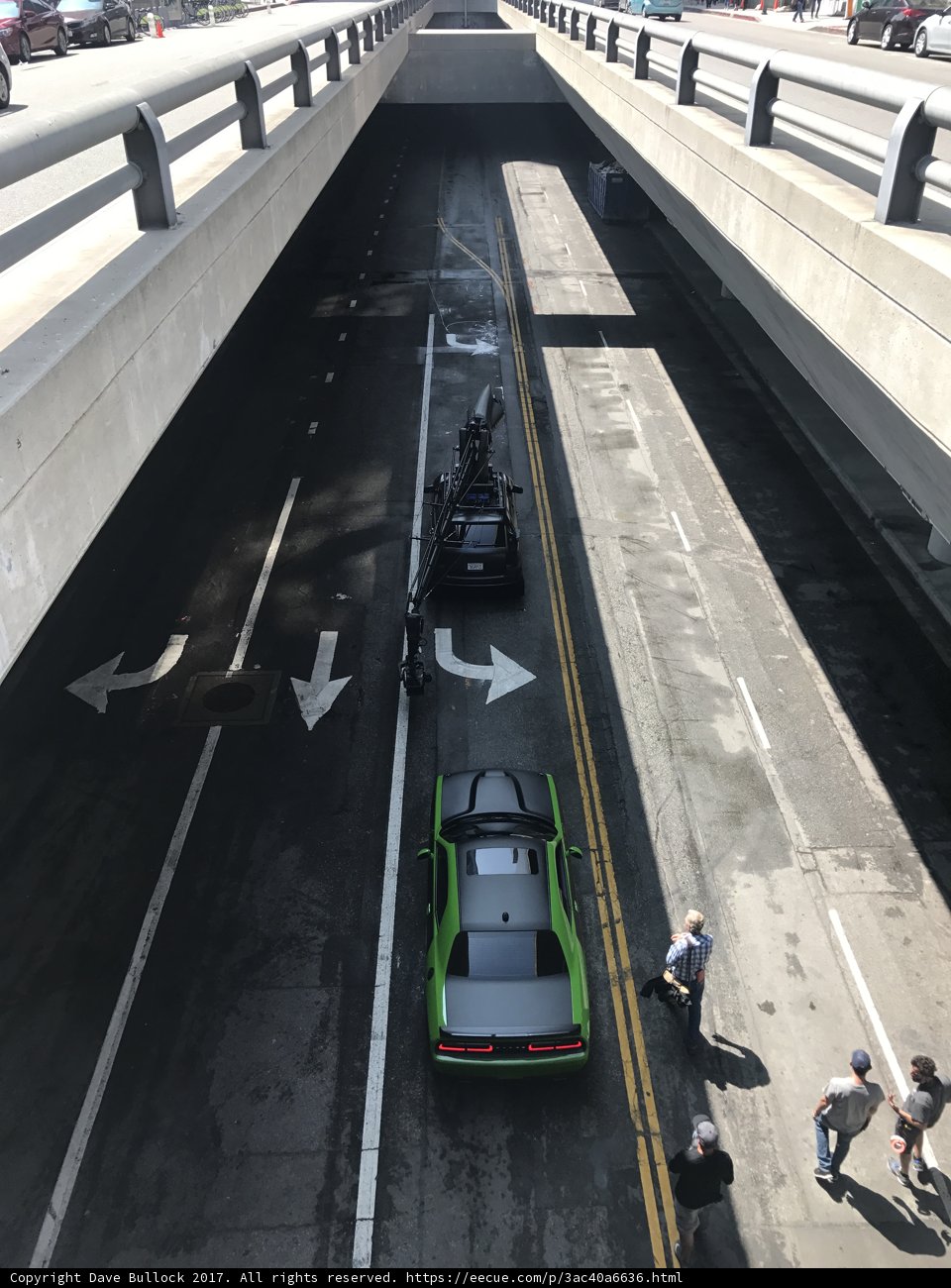Green Car Parked Under Bridge