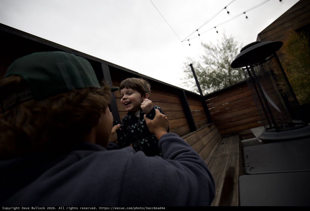 Joyful Moment Between Child and Adult on Outdoor Deck