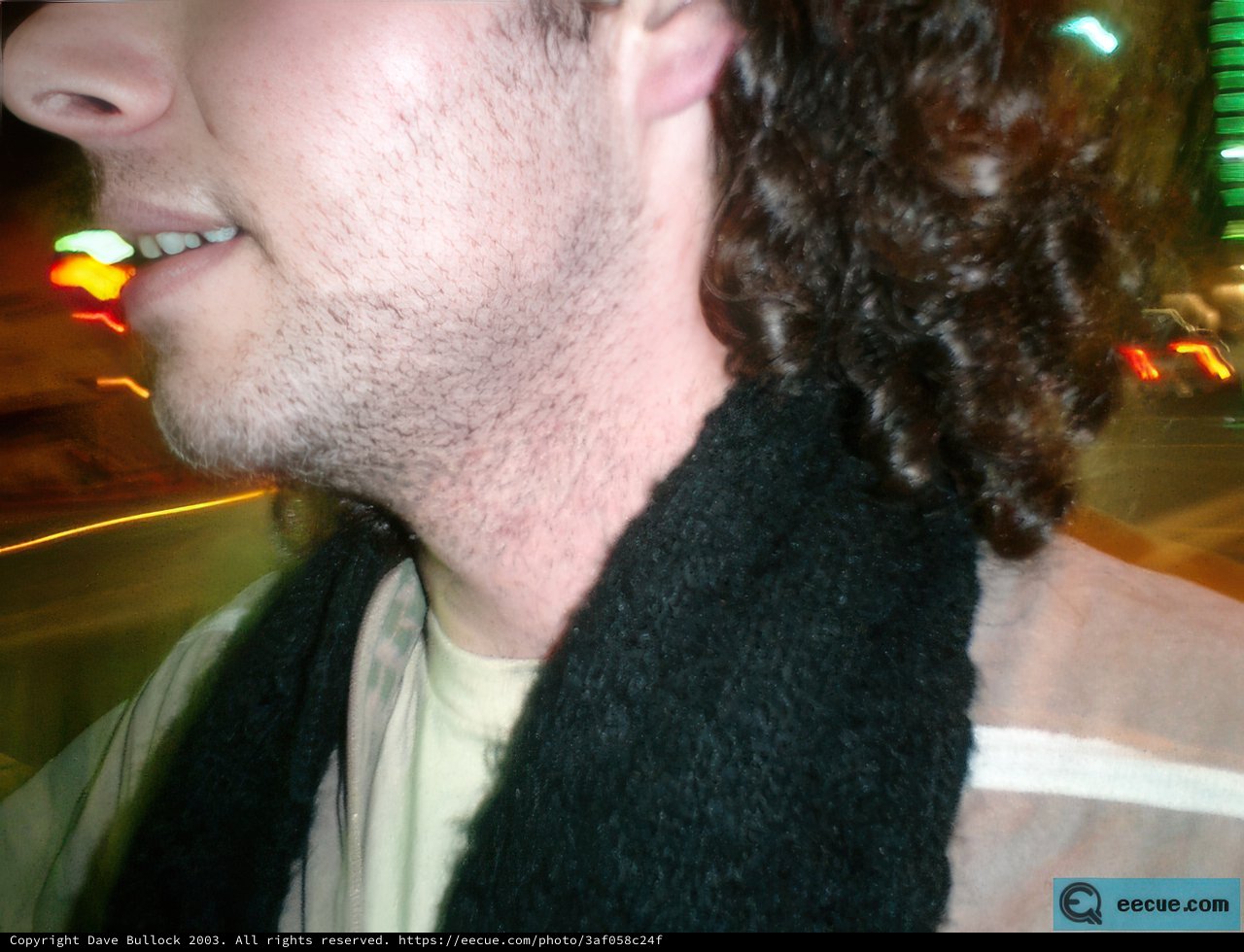 Curly Haired Man in Nighttime Drive