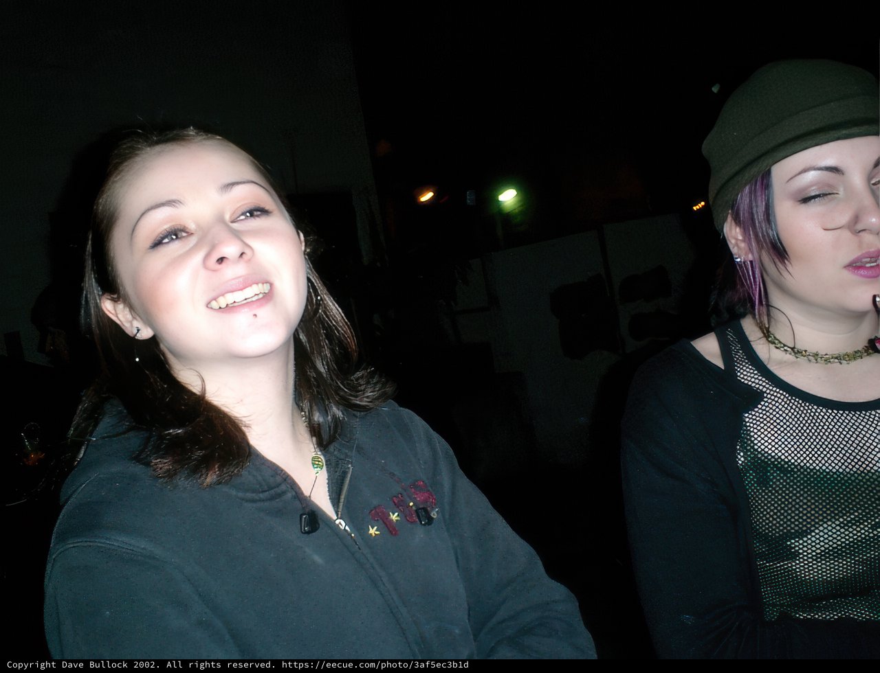 Two Women Sporting Beanies and Baseball Caps