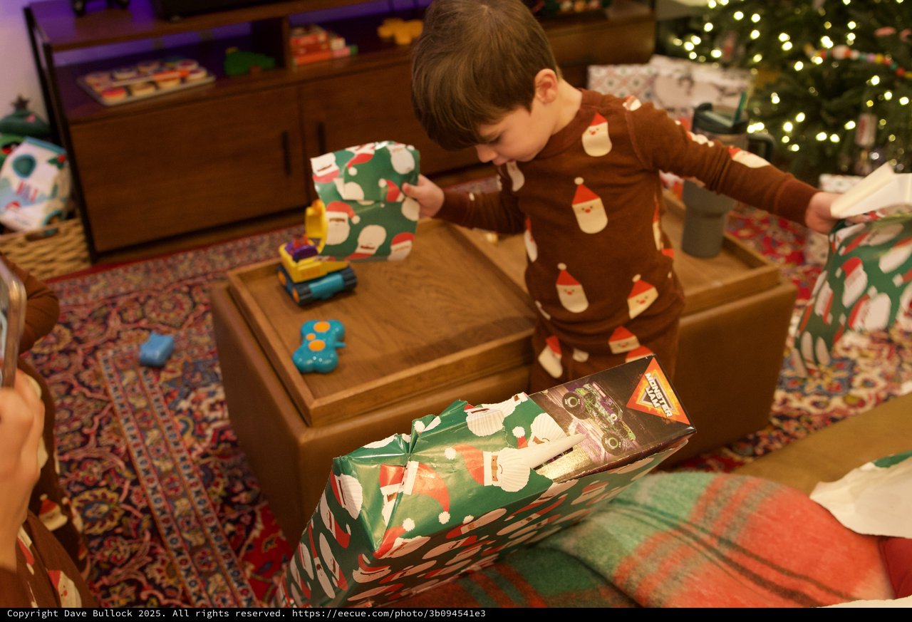 Child Opening Christmas Presents on Holiday Morning
