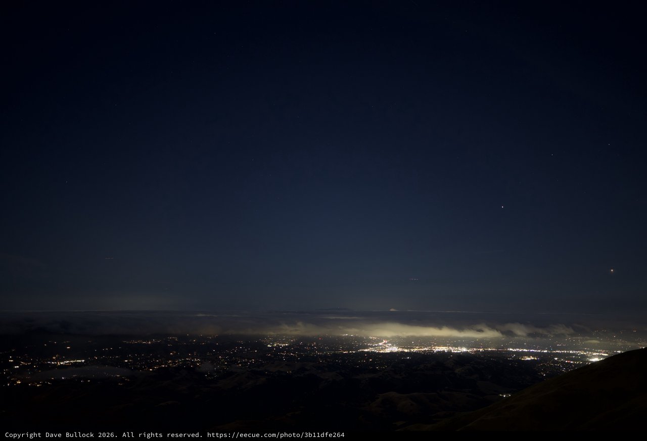 City Lights Glow Beneath Foggy Night Sky from Mount Diablo