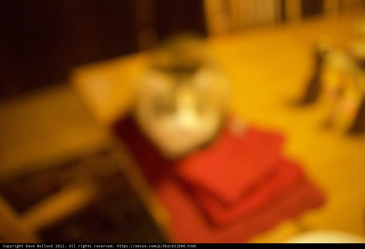 Blurry Feline on a Wooden Table