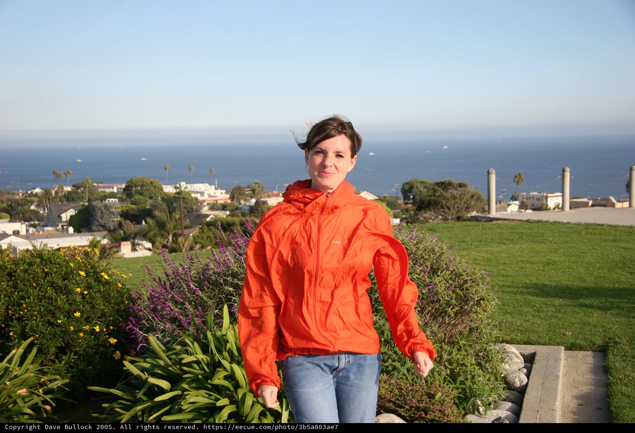 Woman in Orange Jacket Overlooking Coastal California Town