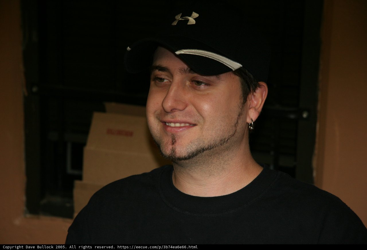 Black Shirted Man Wearing a Baseball Cap