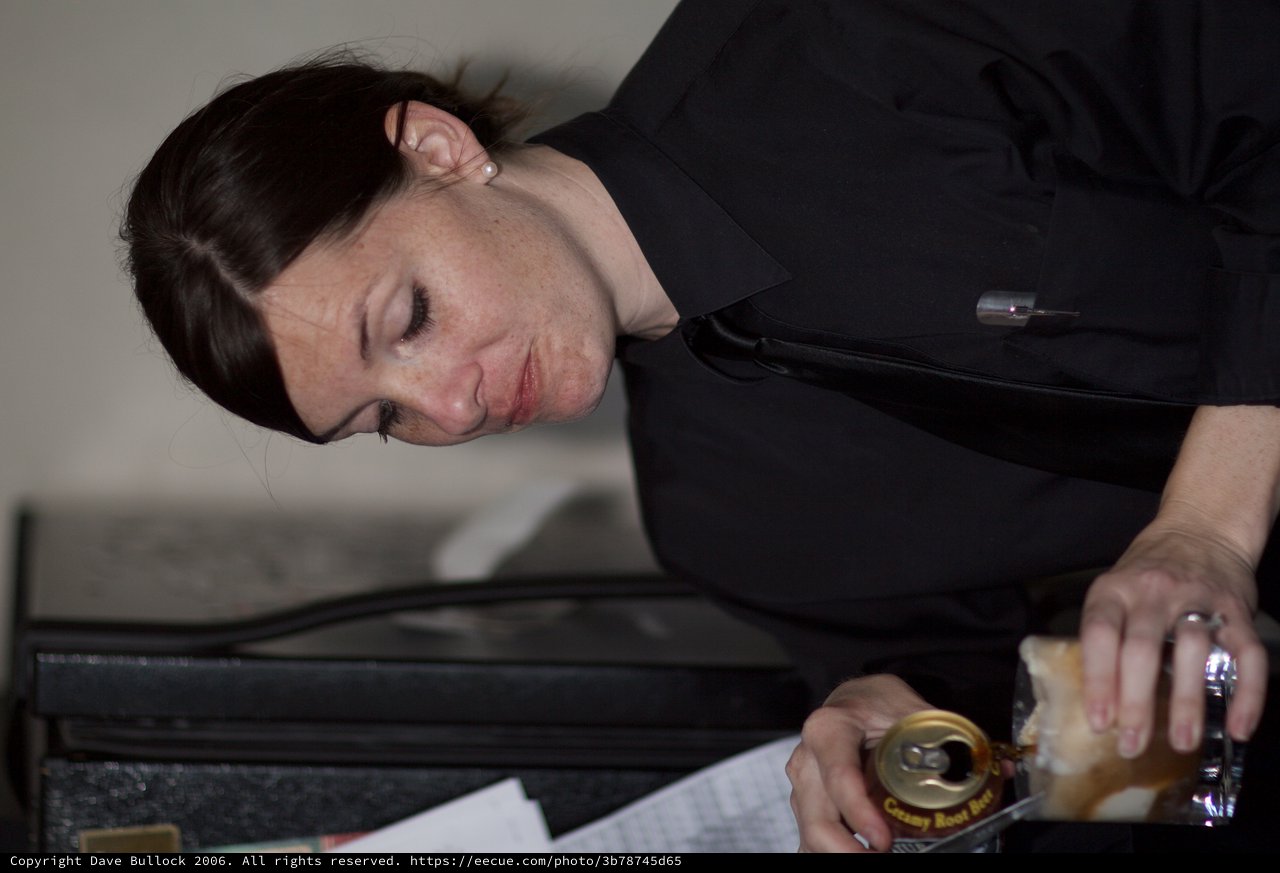 Bartender Pouring Drink in Formal Black Attire