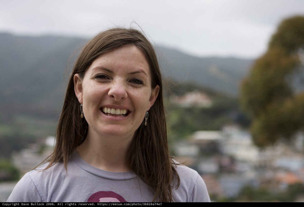 Smiling Woman Portrait Overlooking Mountain Town