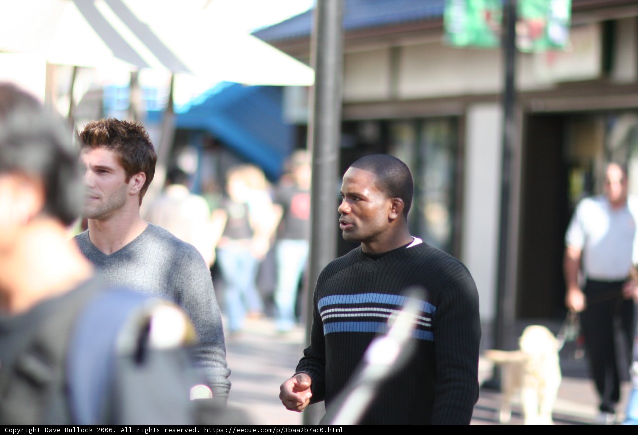 Two Men Strolling with Umbrellas