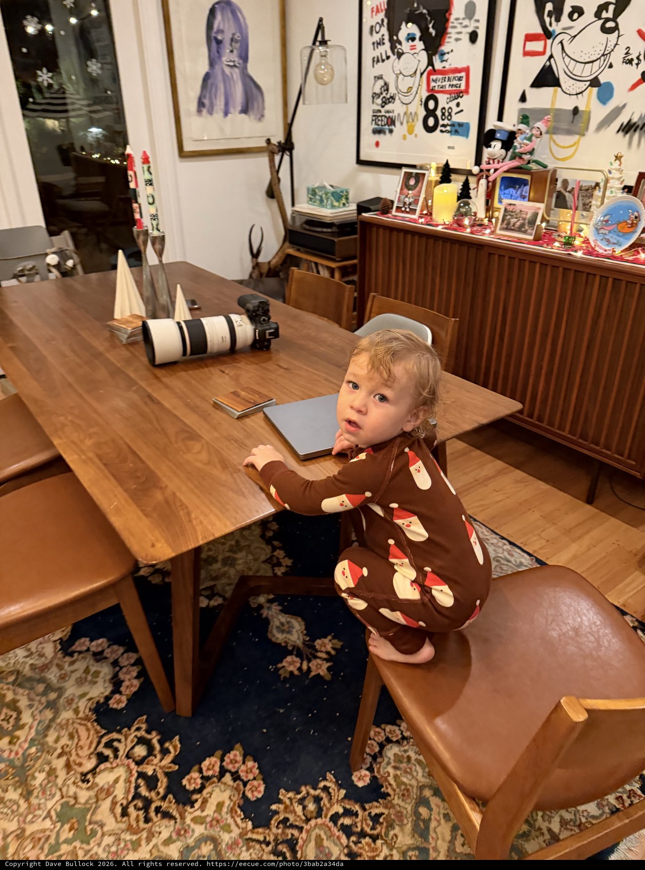 Toddler in Santa Pajamas at Christmas Dining Table
