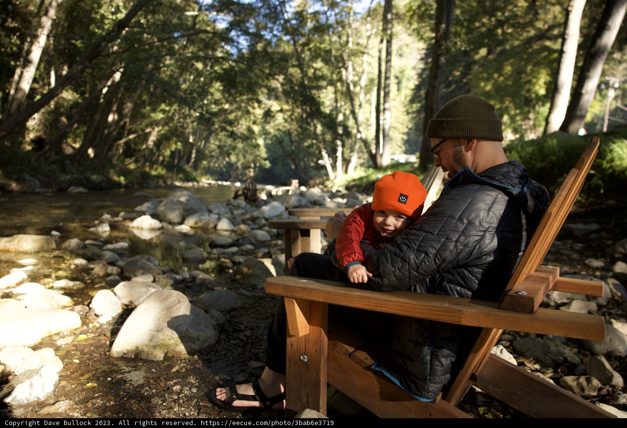 Serenity by the Stream: A Father and Child Moment