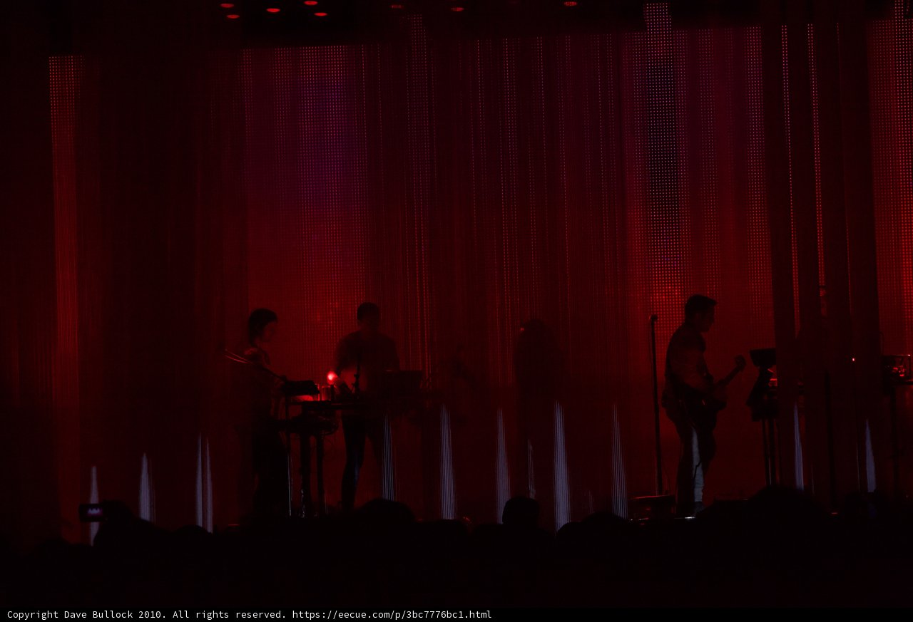 Red Lights on Stage with Performers and Crowd