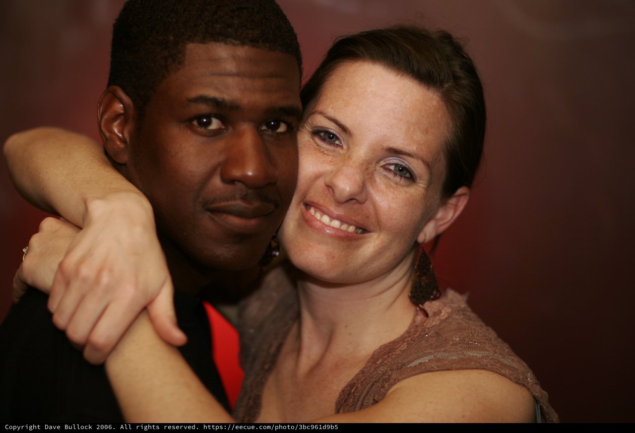 Joyful Couple Embrace at Evening Social Event