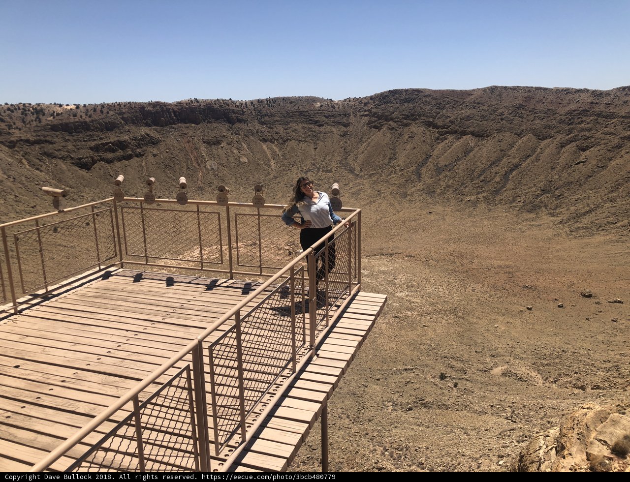 Taking in the View: Girl Stands on Crater's Edge