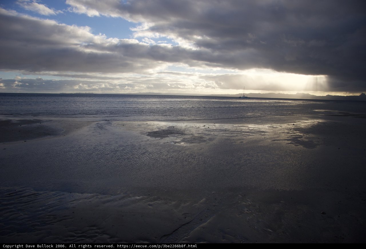 Serene Beachscape with Blue Skies and Fluffy Clouds