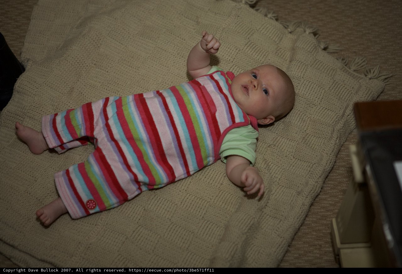 Bright-Eyed Baby Resting on Cozy Knit Blanket