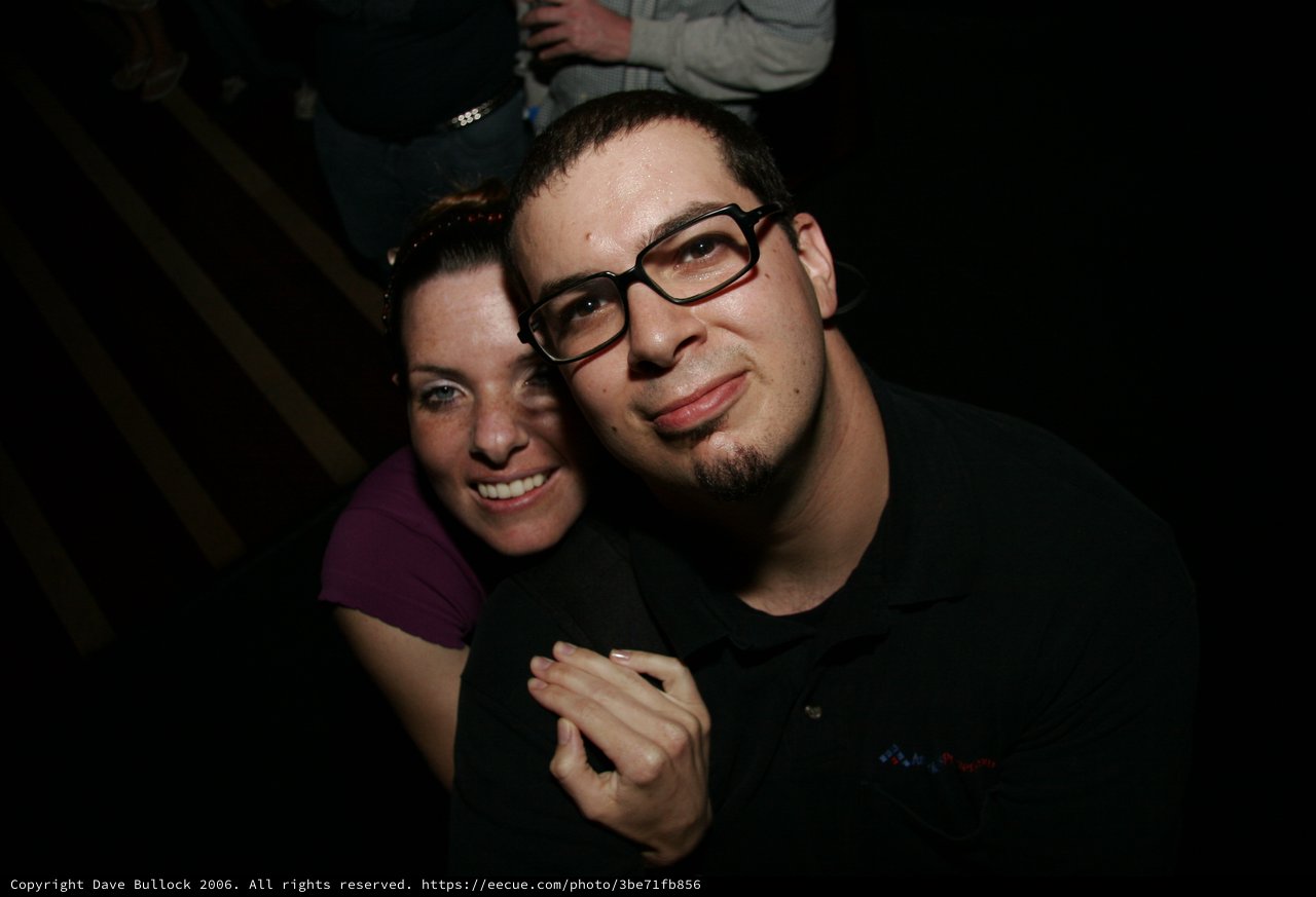 Two Friends Smiling Together at a Nighttime Event