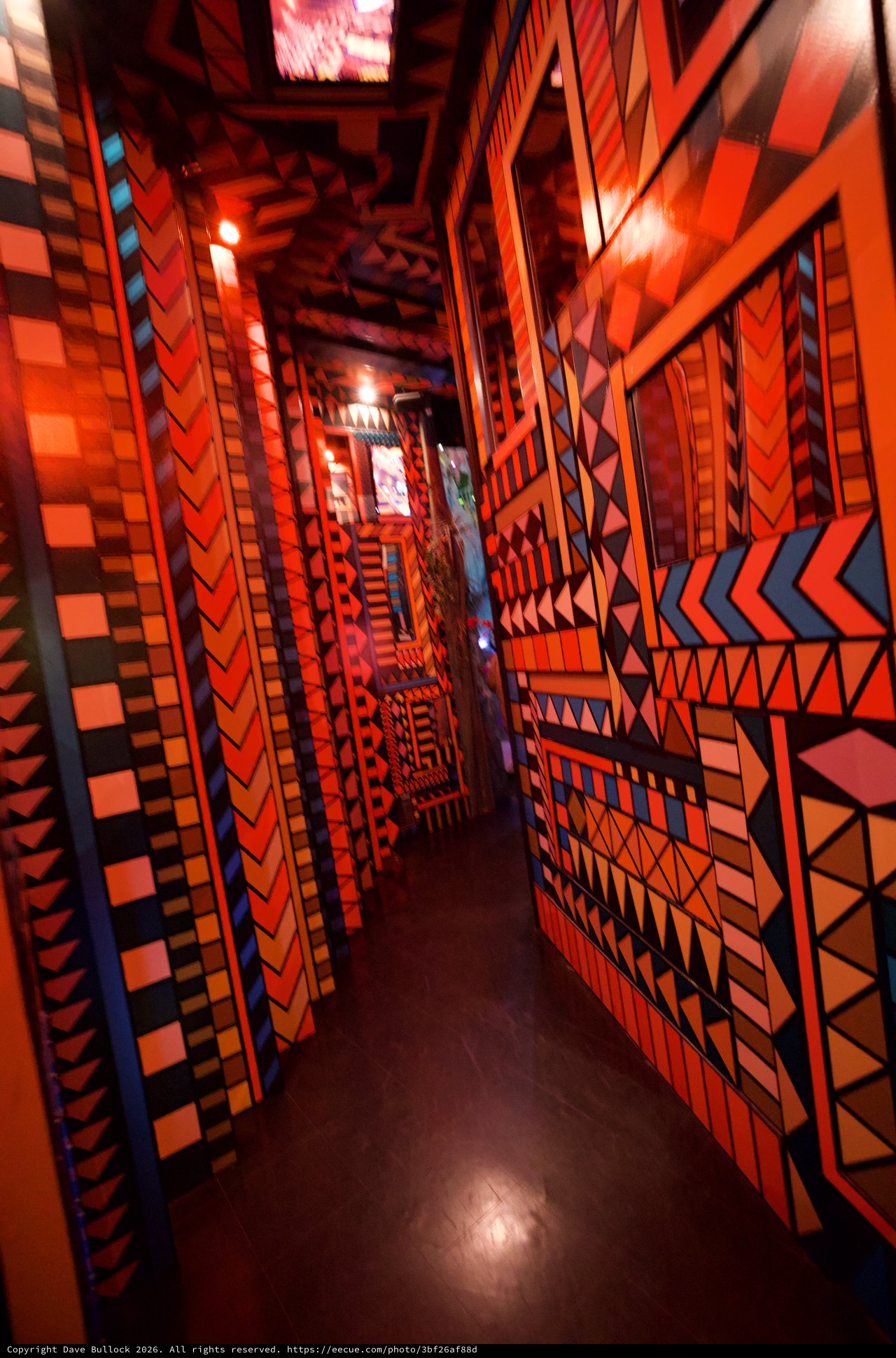 Vibrant Geometric Corridor with Bold Orange Patterns