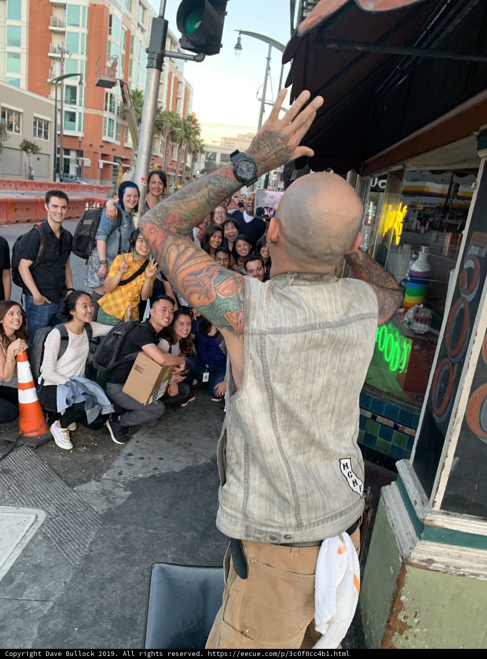 Tattooed man poses with group in San Francisco
