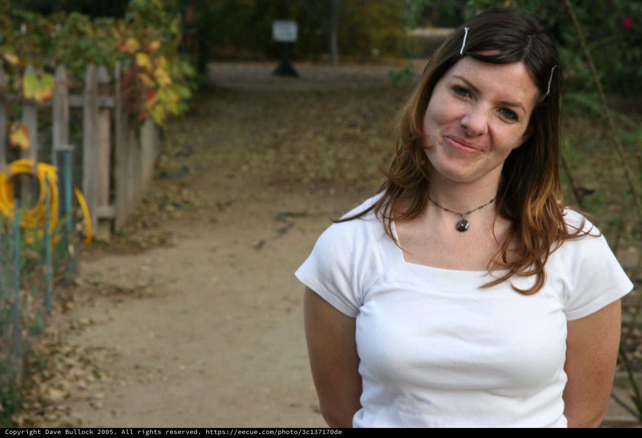 Smiling Woman on Autumn Garden Path