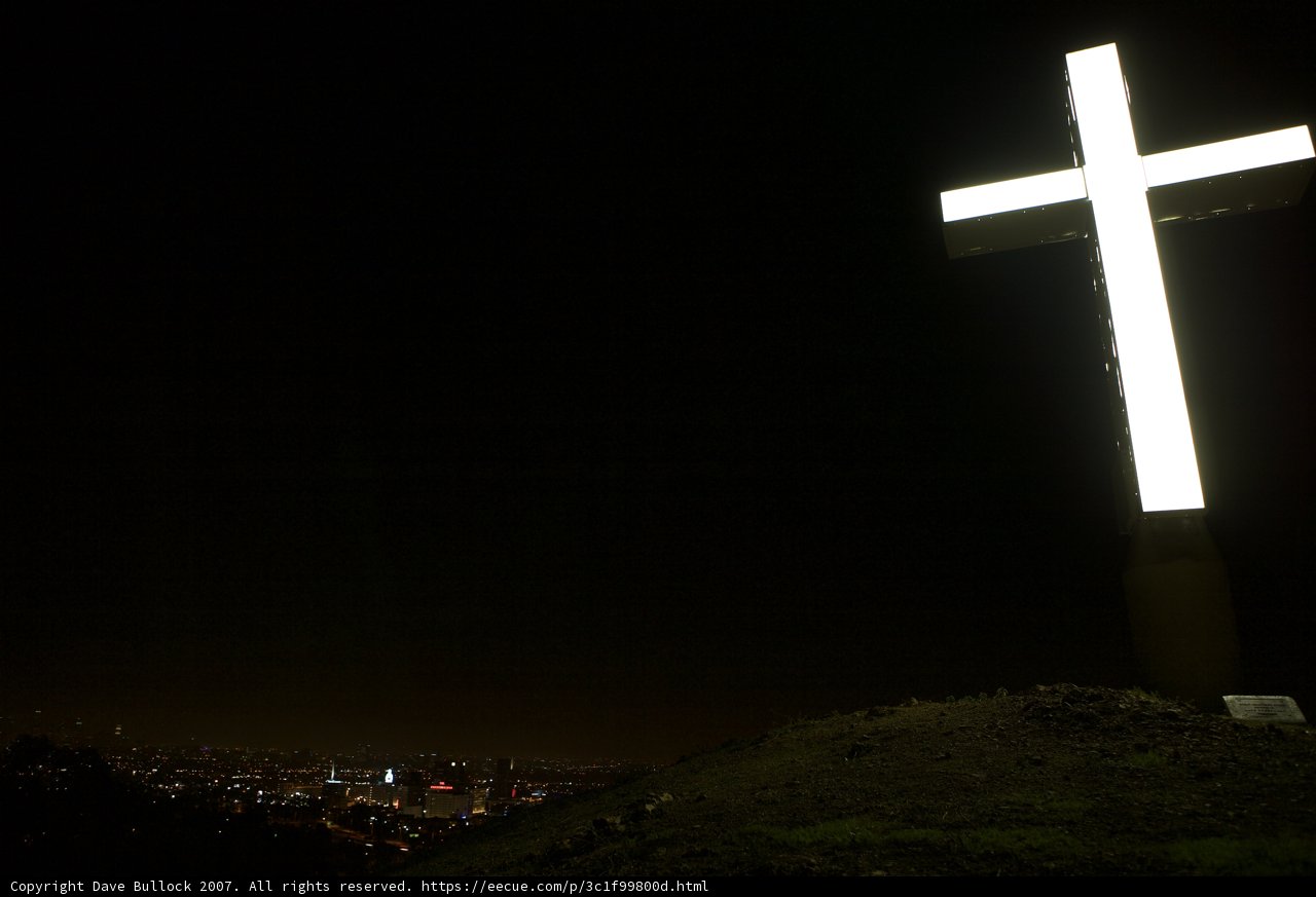 Illuminated Cross Stands Tall Amidst the City