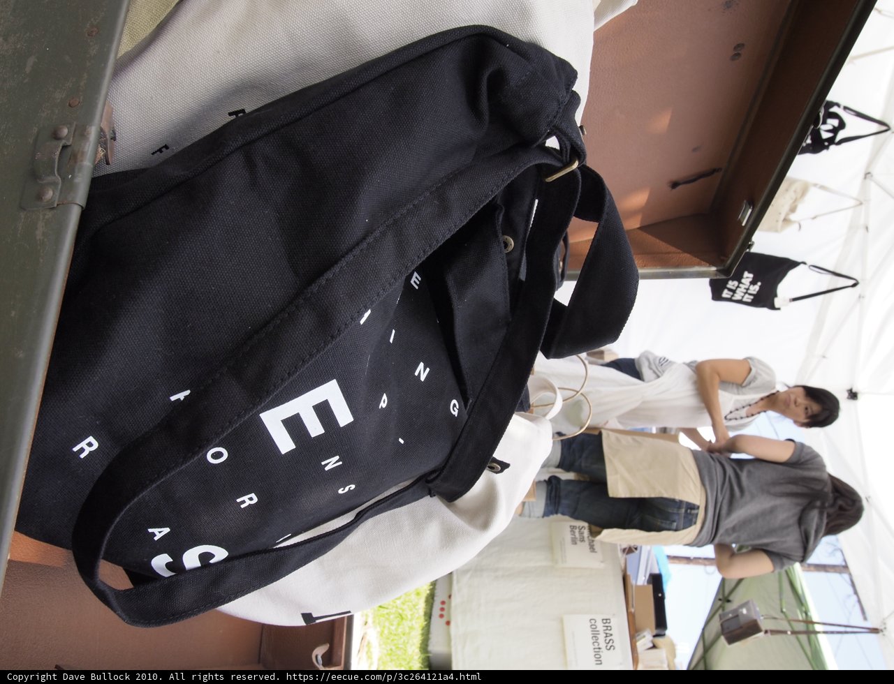 Masae Ueno carrying black bag with white letters
