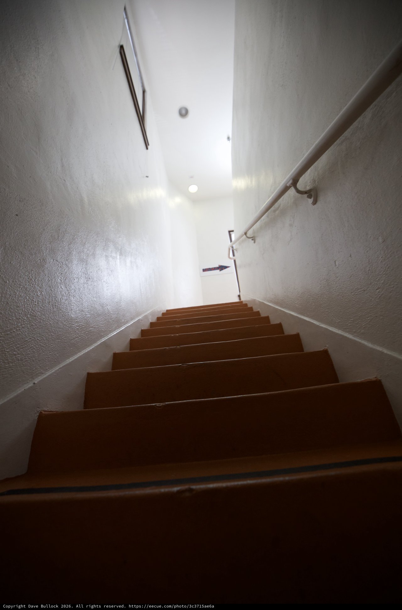 Ascending the Narrow Gallery Staircase in Bright Light