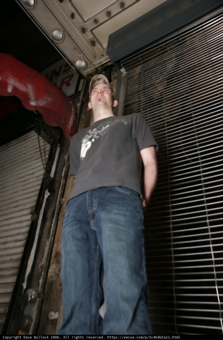 Gray Shirted Teen Leans on Handrail
