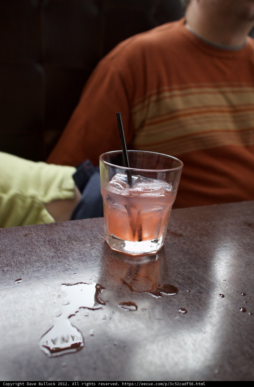 Man Sipping on a Refreshing Cocktail