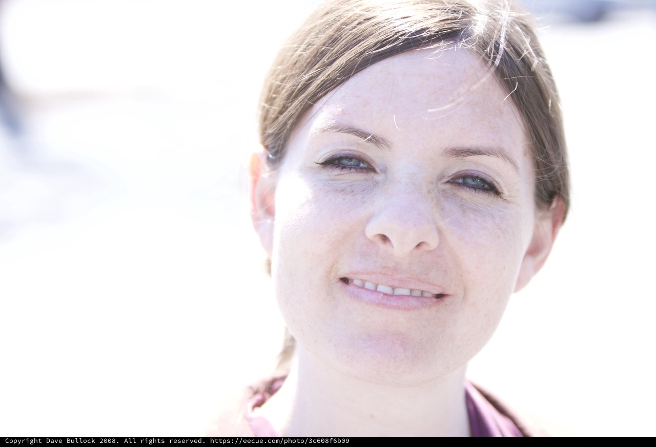 Freckled Woman Smiling in Bright Outdoor Light
