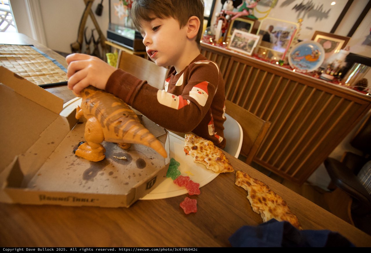 Young Boy Enjoying Pizza on Christmas Day
