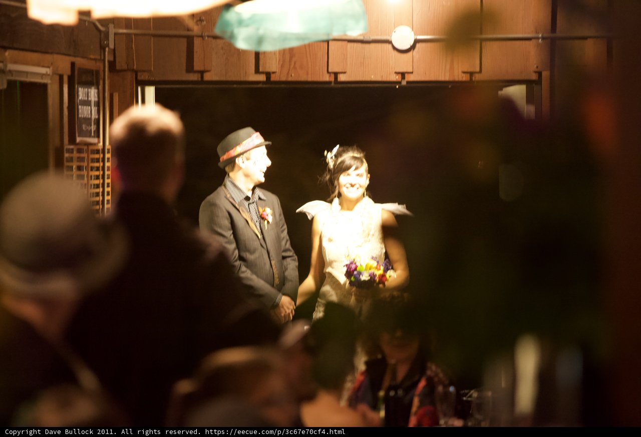 The Newlyweds with a Beautiful Flower Arrangement