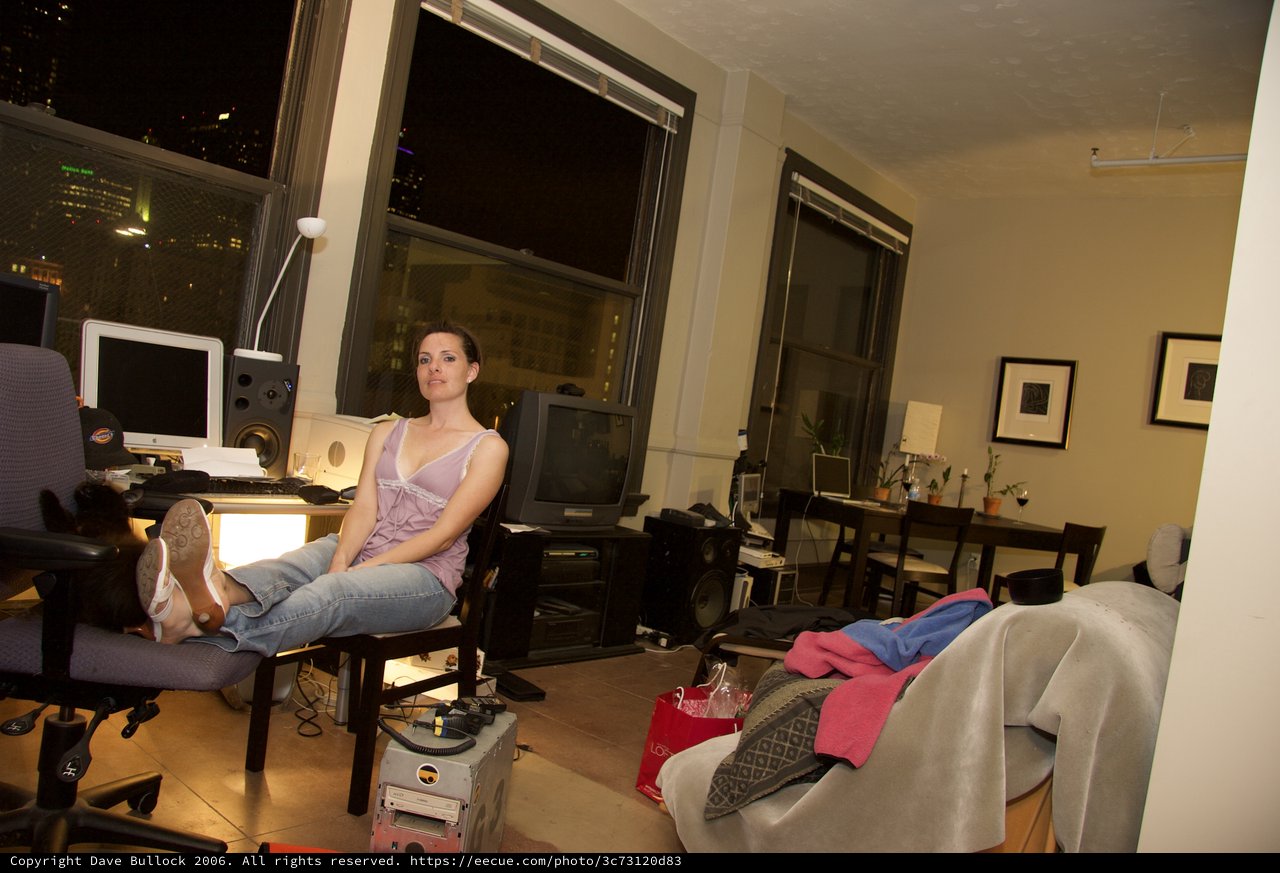 Woman Relaxing in Urban Loft Apartment at Night