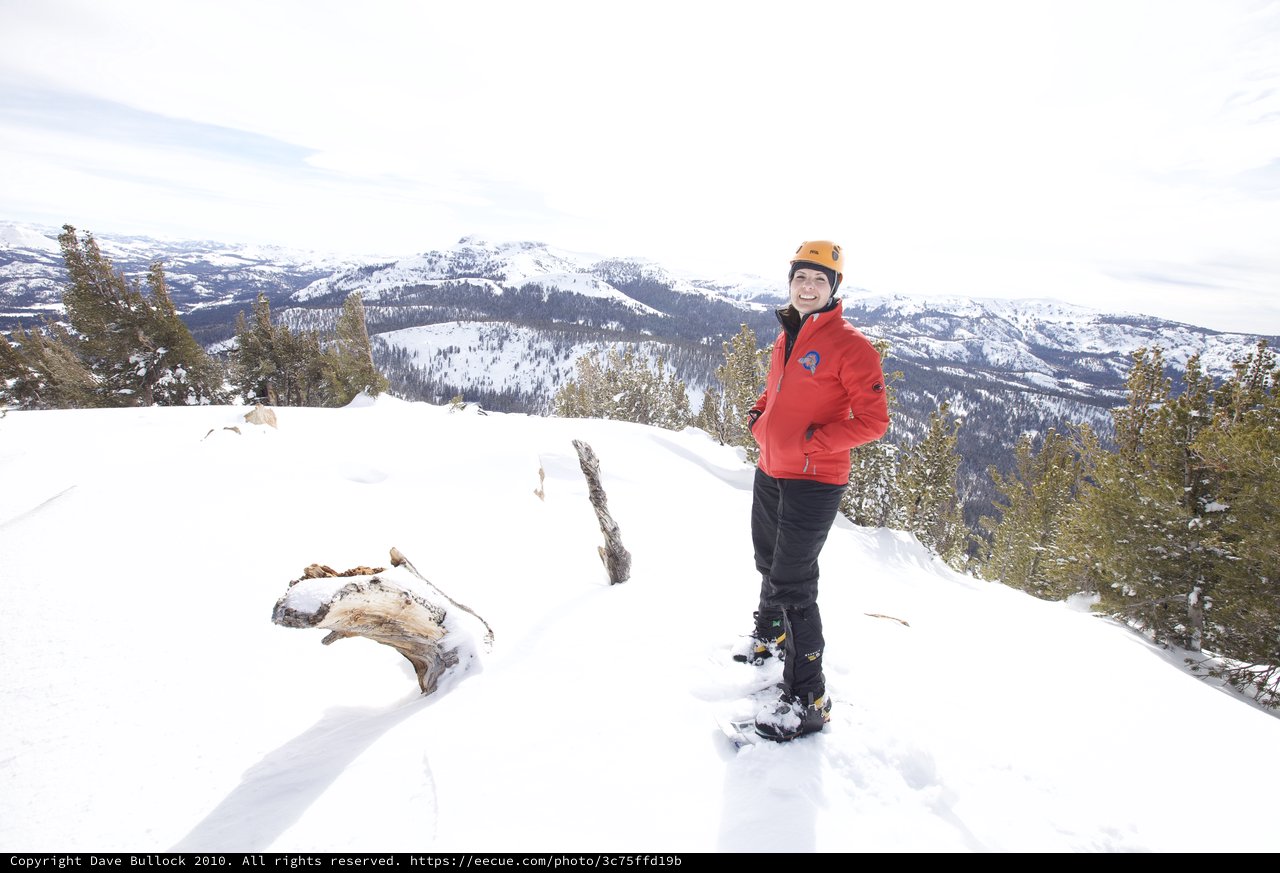 Summit Smiles: Snowshoer Atop Snowy Sierra Peak