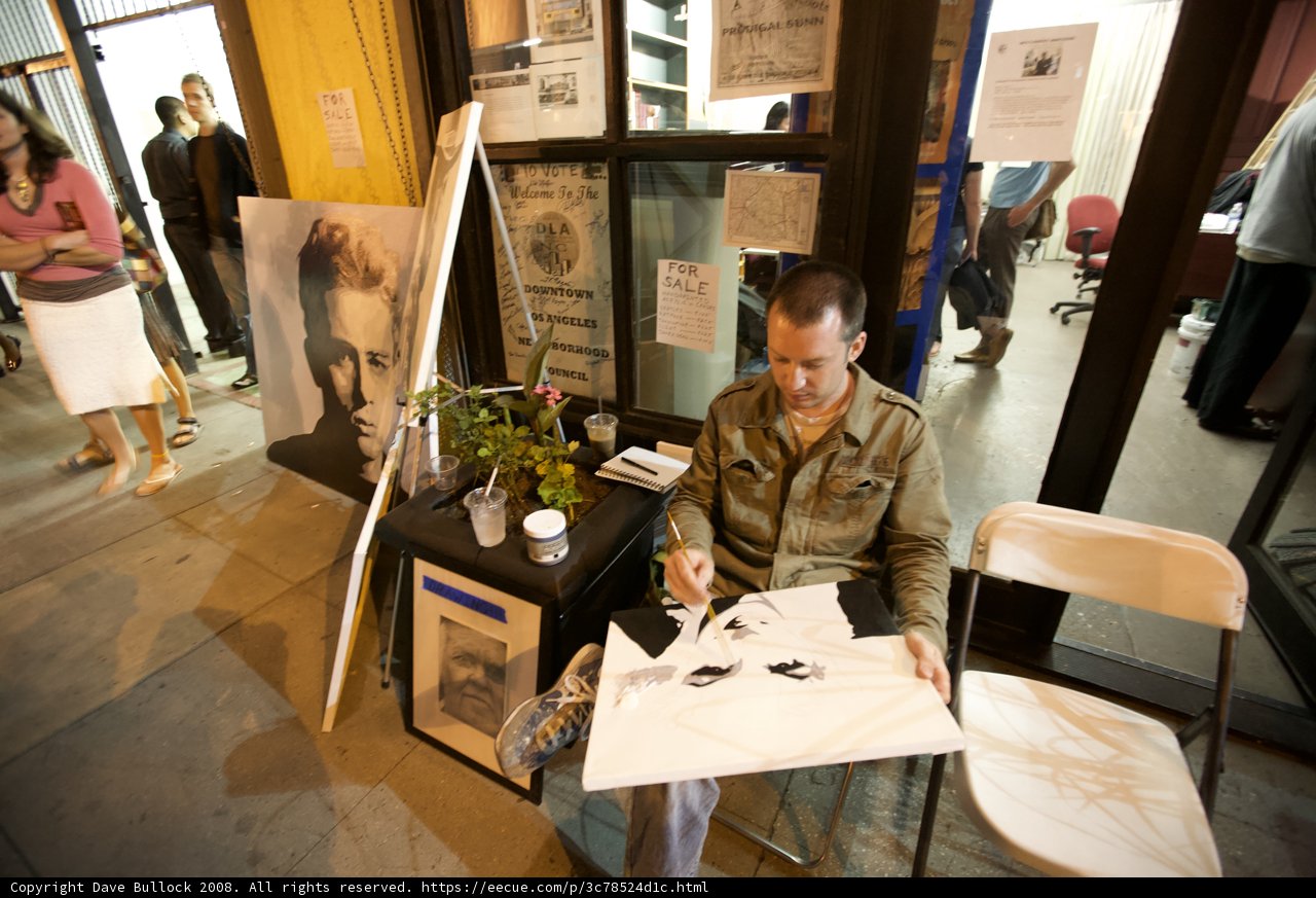 Man Contemplates Artwork at Cafe