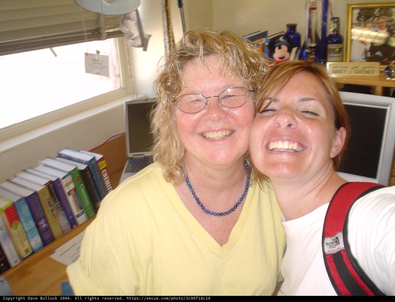 Two Women Laughing Together in Office Setting
