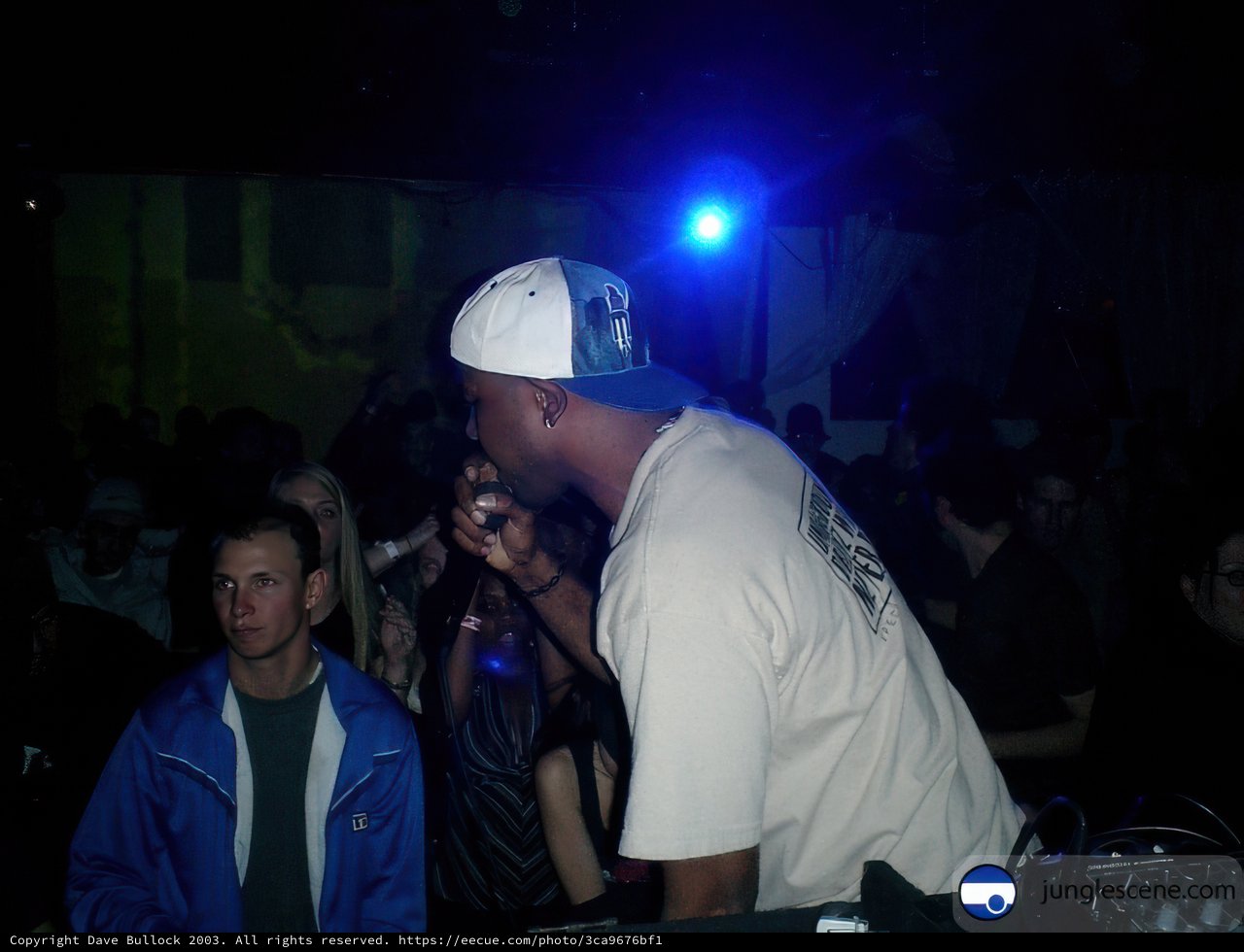 Man in White Baseball Cap Addresses Nightclub Crowd