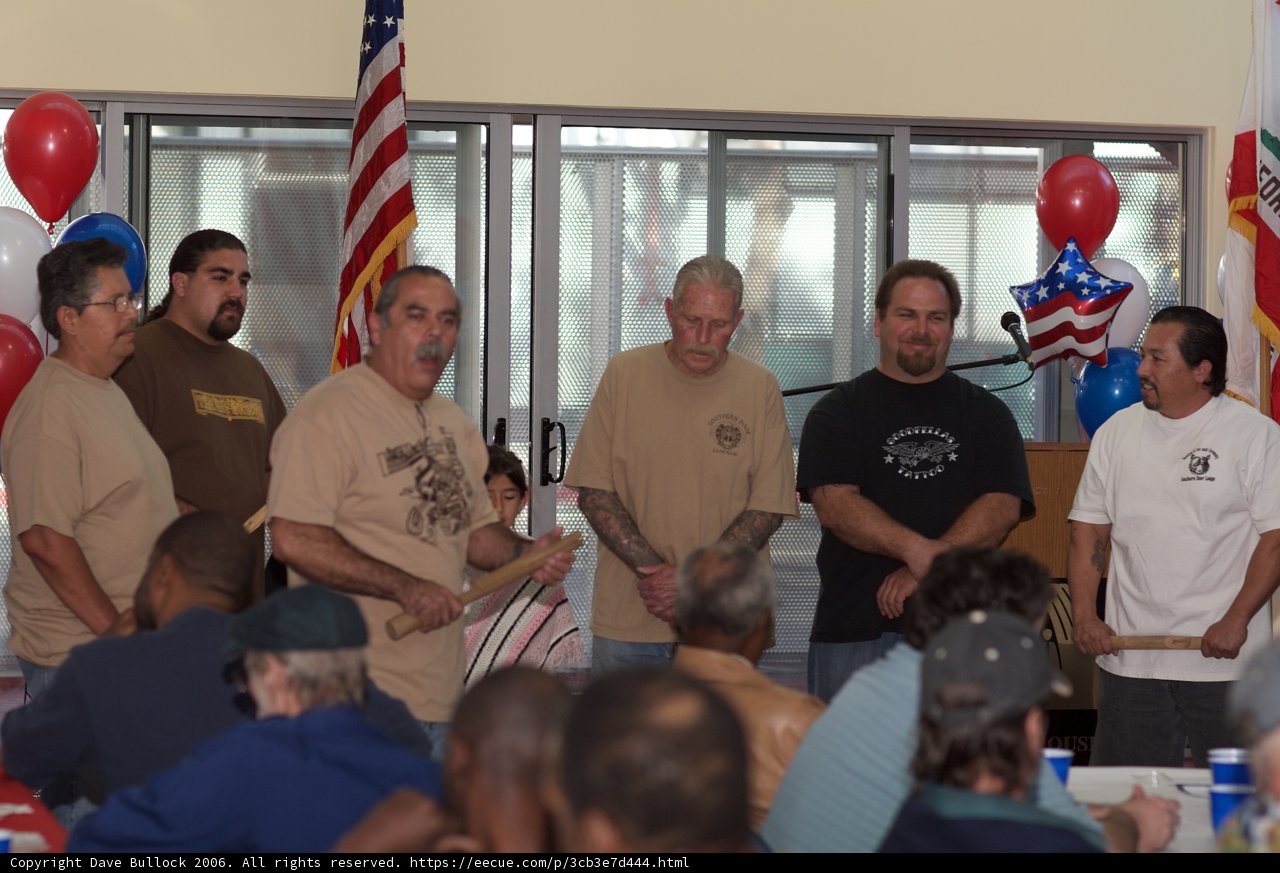 Gathering of Men at Plywood Table