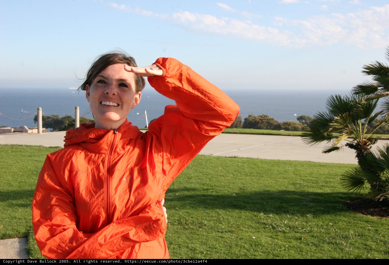 Woman in Orange Jacket Gazes at the Pacific Ocean