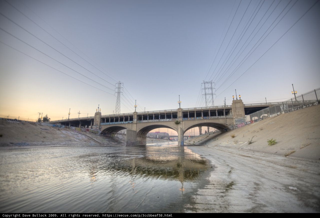 Arch bridge over LA river with power lines
