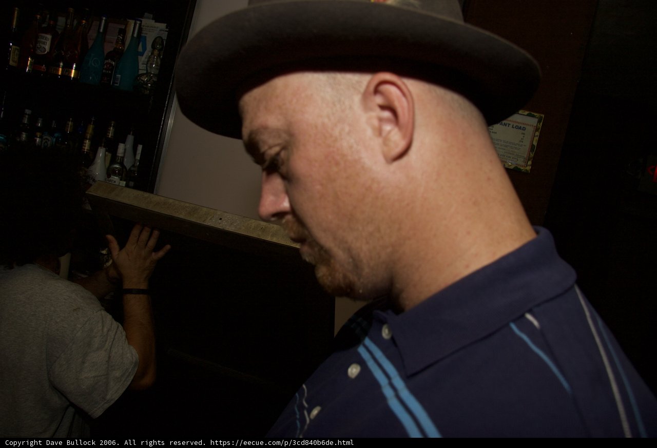 Hat-wearing Man in a Pub