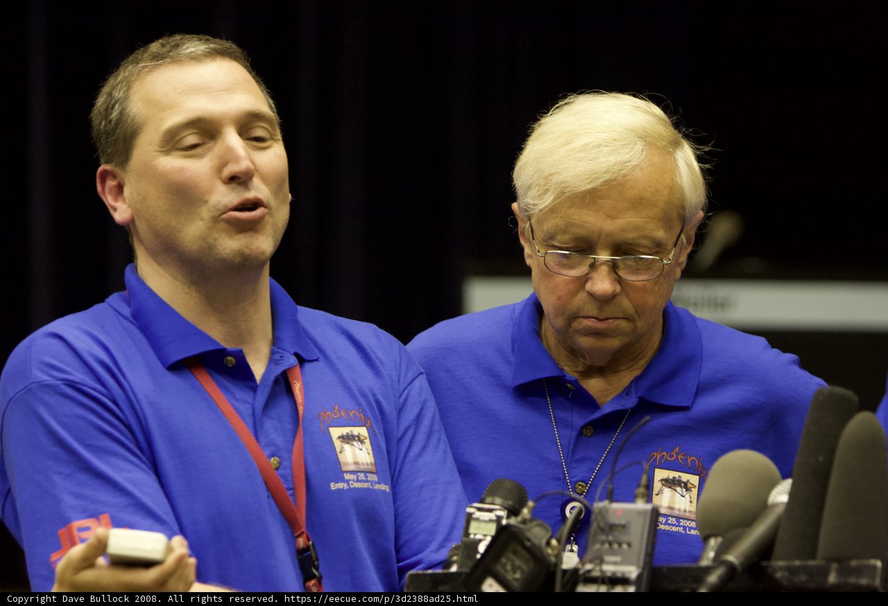 Press Conference with Two Men in Blue Shirts