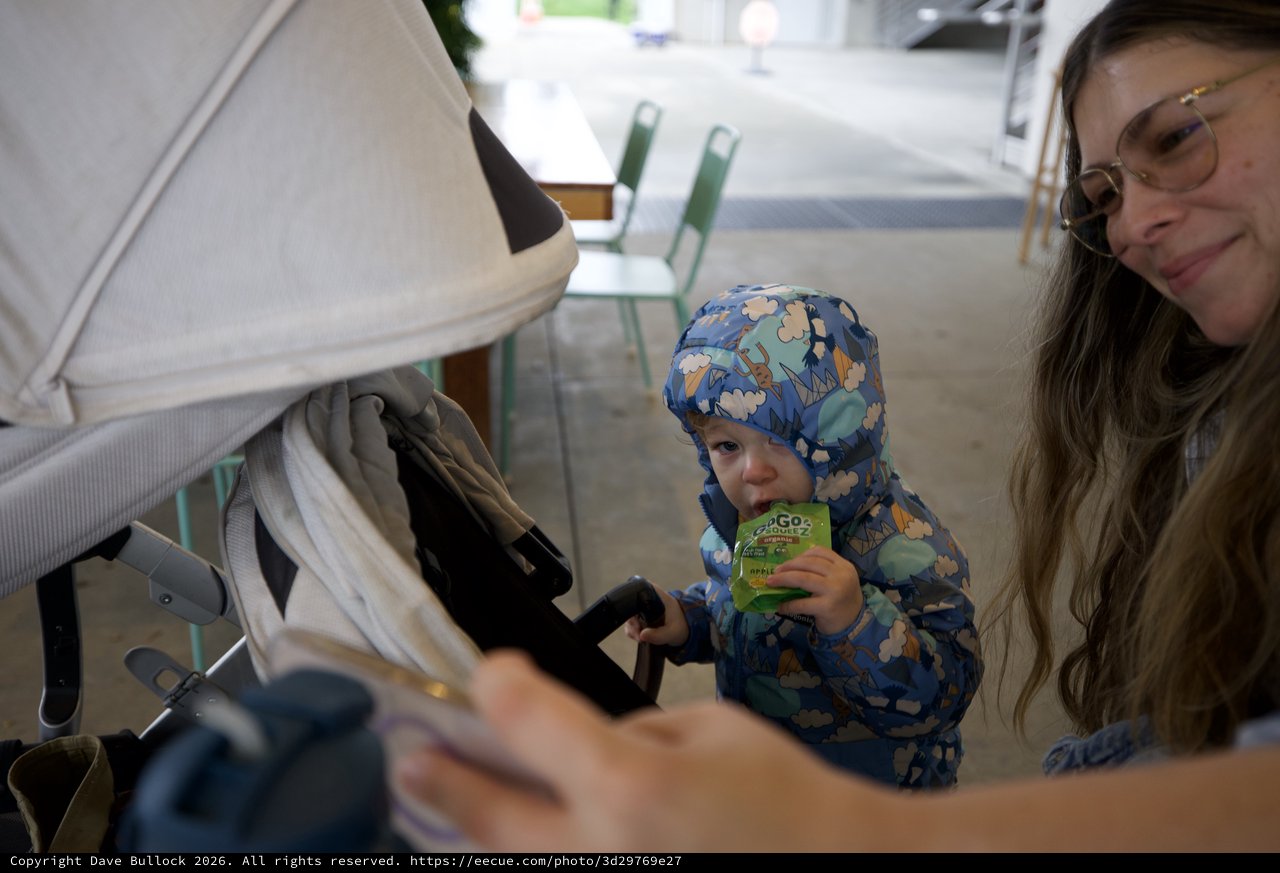 Family Moment at Cafe with Toddler in Blue Snowsuit