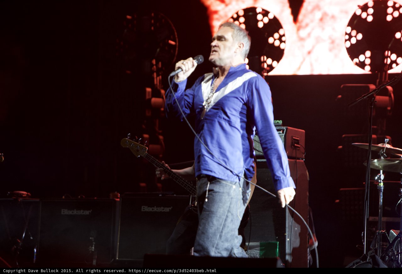 Morrissey Full Body Singing Profile Blue Shirt Bassist Two Blackstar Amps Circular Lights Drums