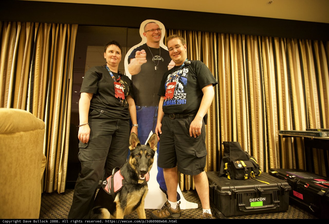 Man, Woman and their furry friend pose in Living Room