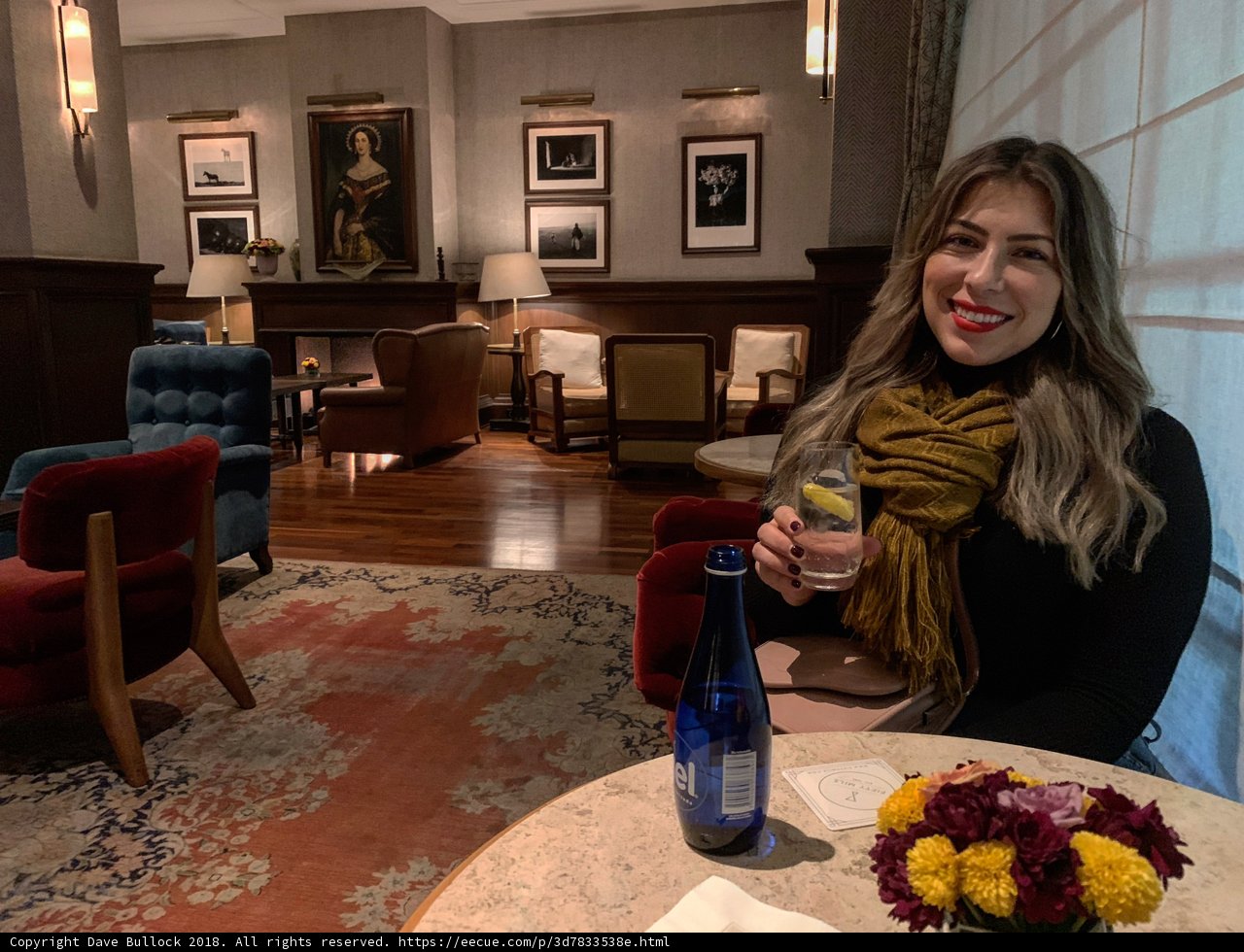 Woman enjoying a glass of wine on a cozy evening