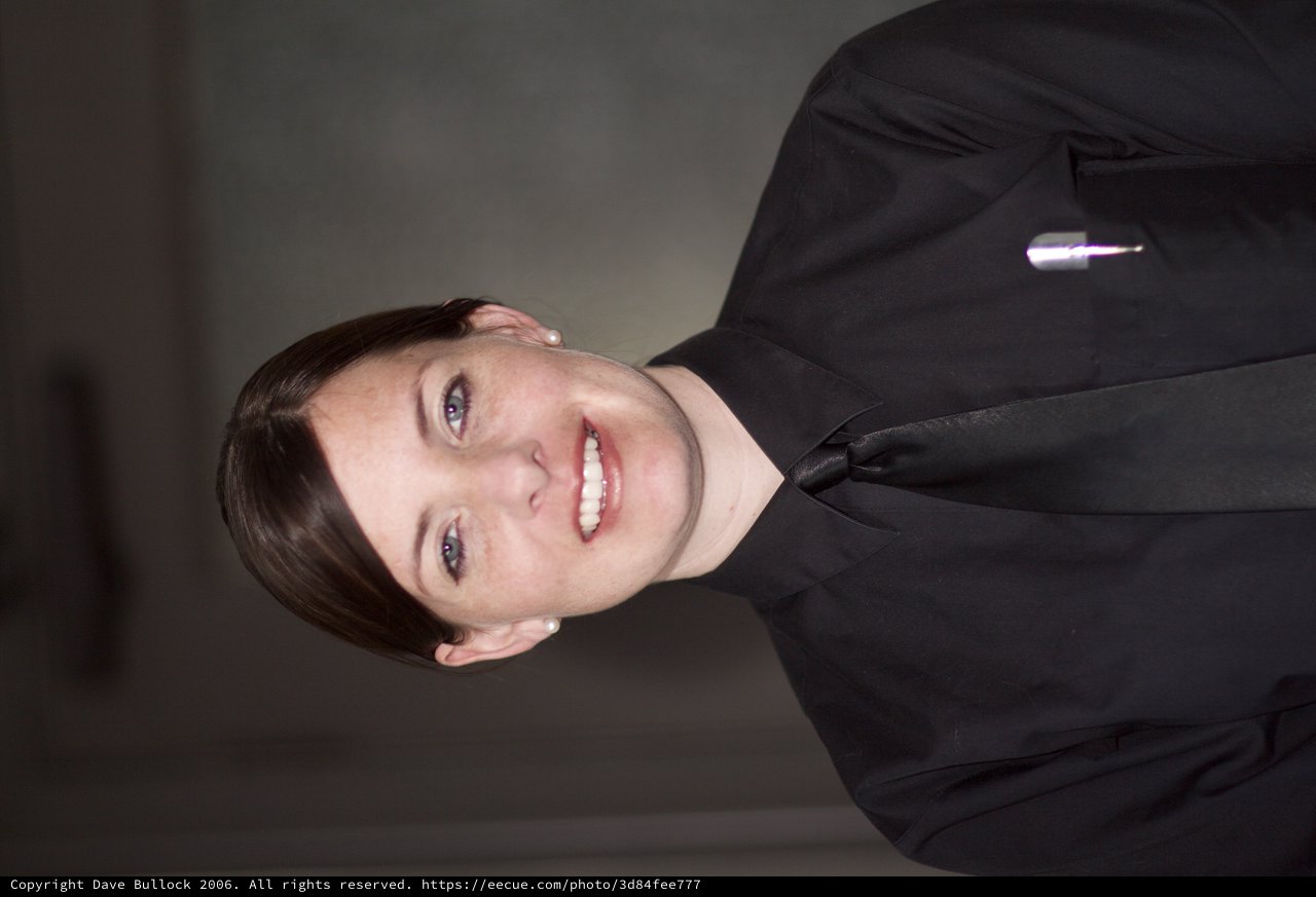 Professional Portrait of Smiling Woman in Black Uniform
